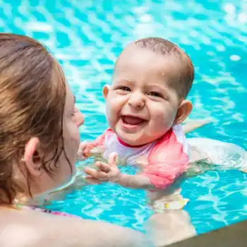 Image of mother swimming with her baby in a fibreglass pool